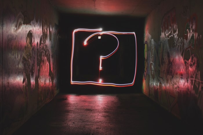 Question mark light art in a graffiti tunnel