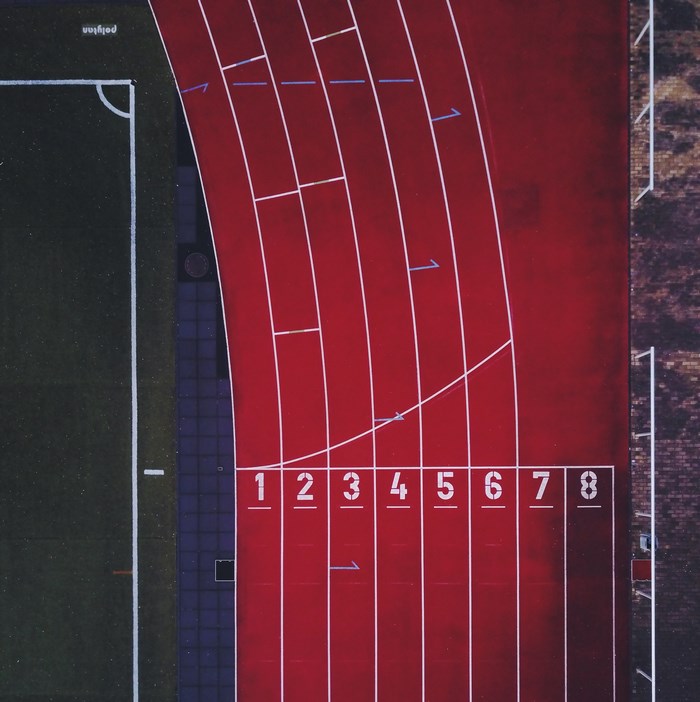 Aerial view of a running track with numbered lanes