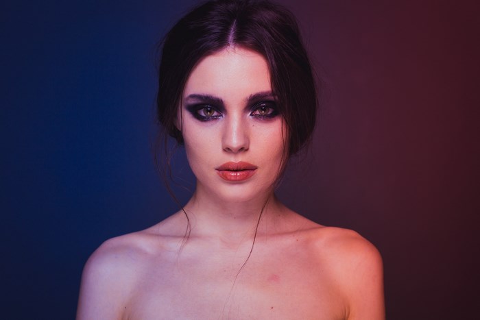 Woman with dramatic makeup and bare shoulders