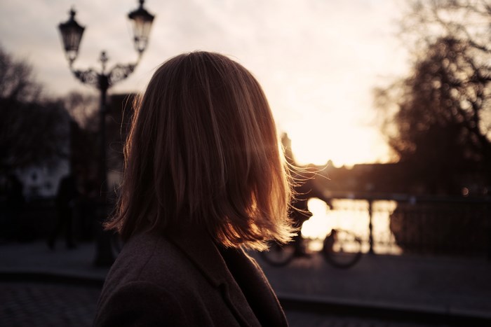 Woman looking at sunset on bridge in Berlin
