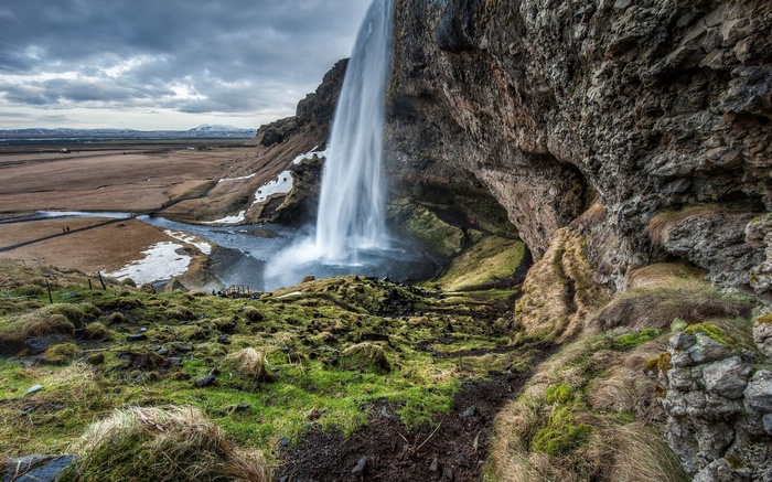 Seljalandsfoss waterfall in Iceland with a cave behind it