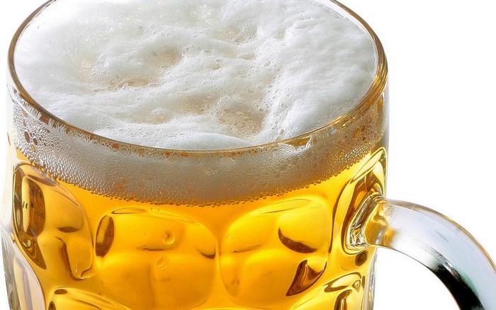 Beer in a glass mug with foam