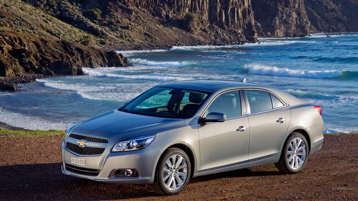Silver Chevrolet Malibu parked by the ocean