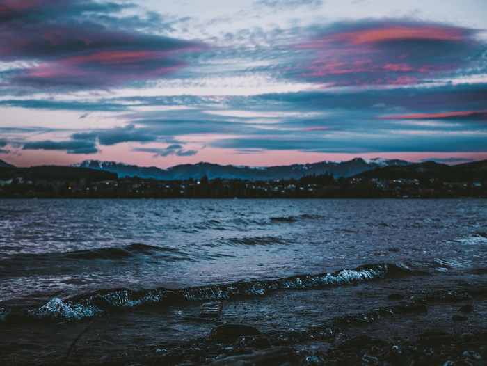 Moody Sunset Over a Lake with Mountains