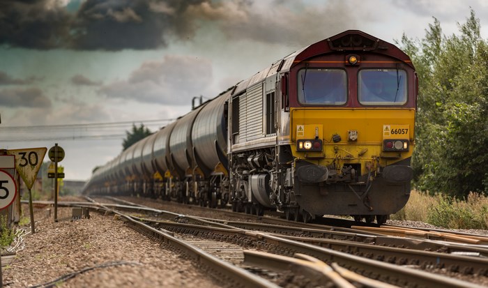 Freight Train on Railway Track under Cloudy Sky