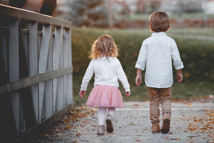 Brother and Sister Walking on Autumn Path