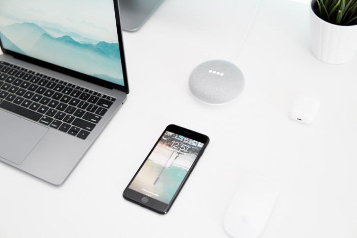 Minimalist Workspace with Laptop, Phone, and Smart Devices