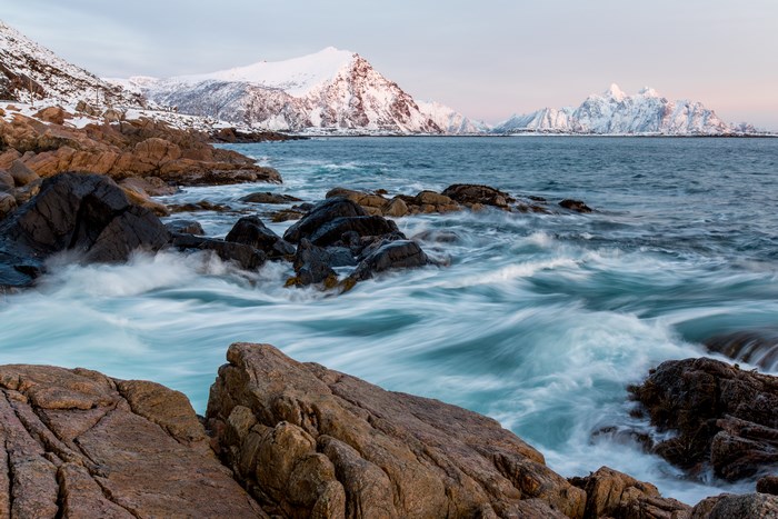 Waves crashing on rocks in Lofoten, Norway during winter