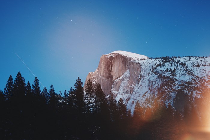 Half Dome mountain with snow and stars