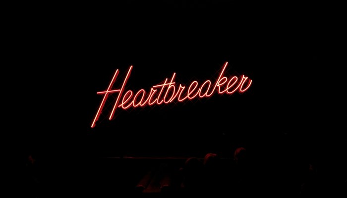 Red neon sign that says Heartbreaker