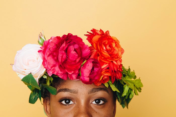 Woman Wearing Vibrant Floral Crown on Yellow Background
