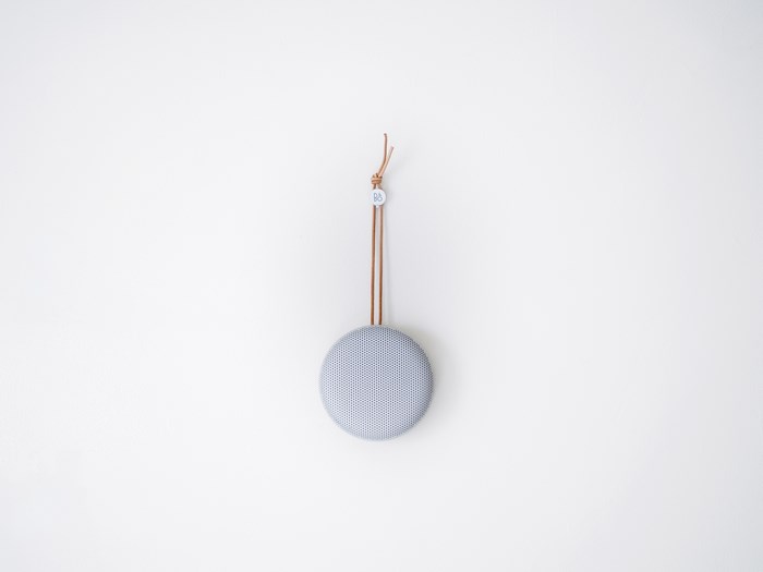 Bang & Olufsen speaker hanging on a white wall