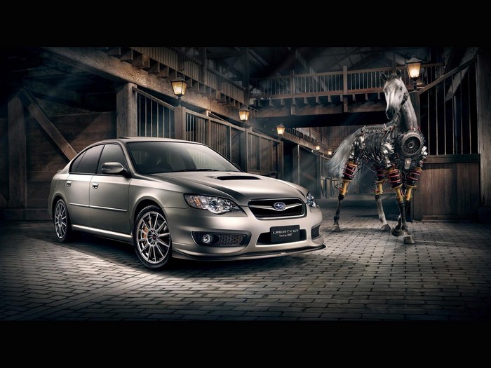 Subaru Liberty GT with mechanical horse in barn