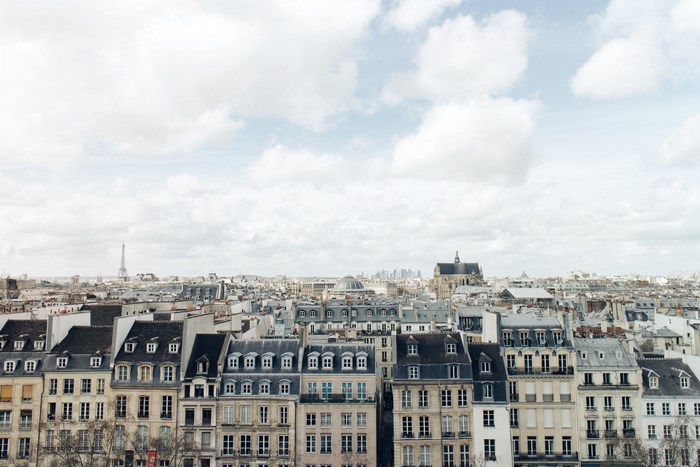 Parisian cityscape with Eiffel Tower under cloudy sky
