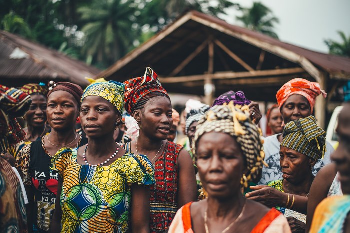 Group of African women in colorful headwraps and dresses