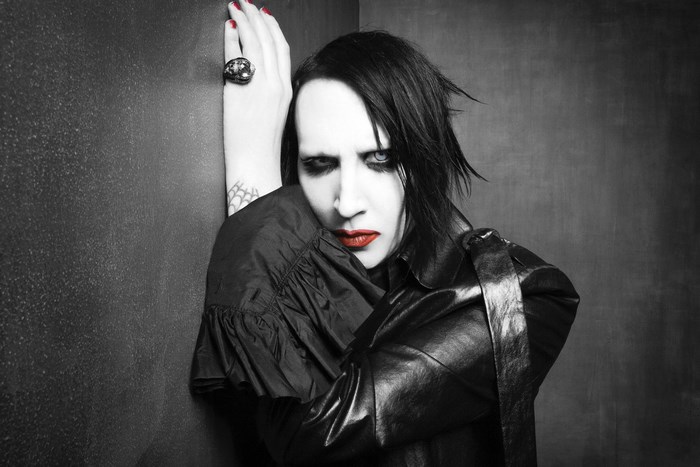 Marilyn Manson leaning against a wall