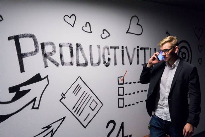 Man in Suit Talking on Phone Near Productivity Wall Art