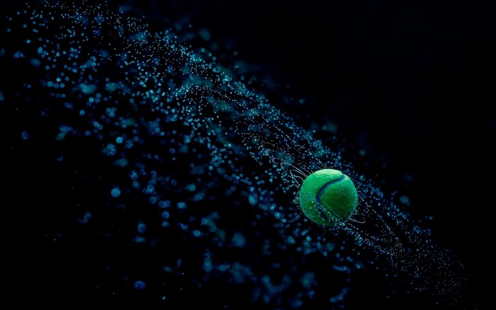 Tennis ball in water droplets