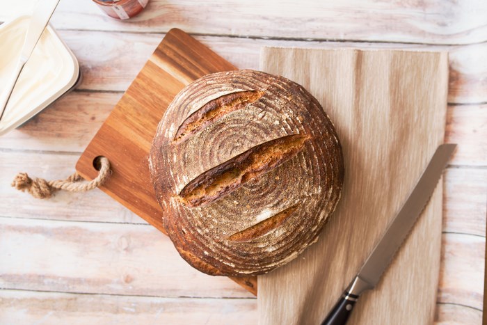 Overhead view of sourdough bread on a cutting board