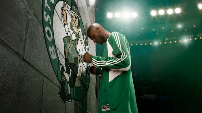 Kevin Garnett leans on Boston Celtics logo