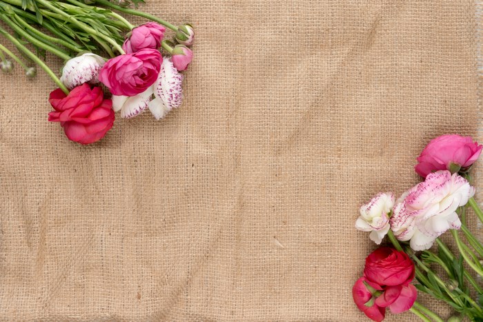 Flatlay of Pink and Red Flowers on Sack Cloth