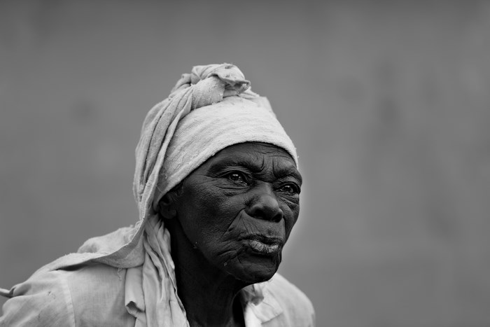 Portrait of an elderly Haitian woman wearing a headwrap