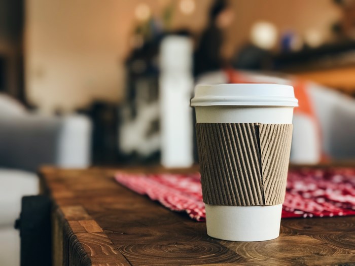 Coffee cup on a wooden table with red cloth