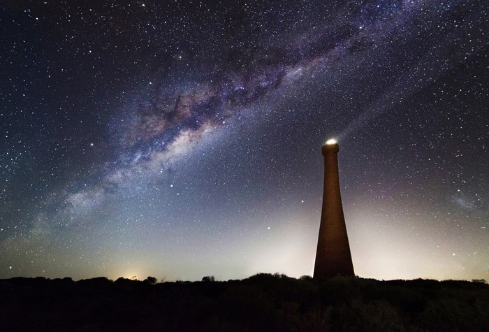 Milky Way over a lighthouse at night