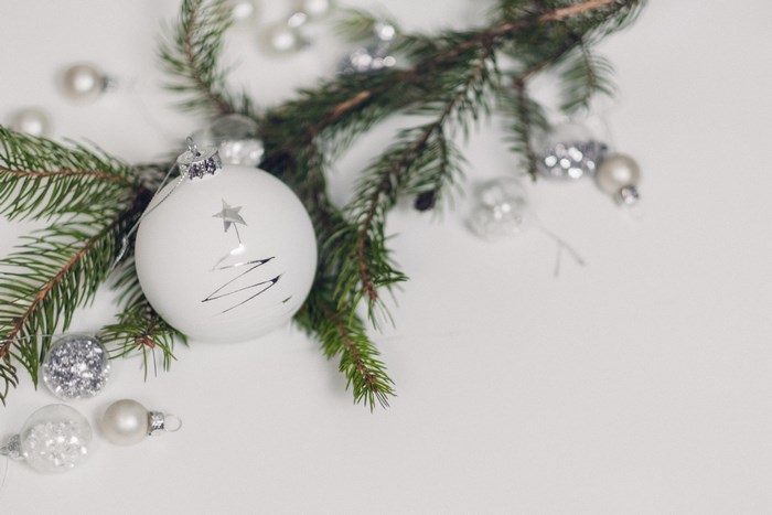 White and Silver Christmas Ornaments on Pine Branch