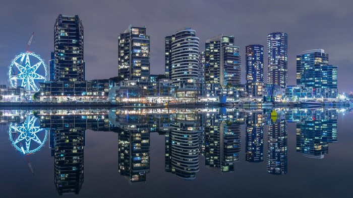 Melbourne skyline with Ferris wheel and reflections at night