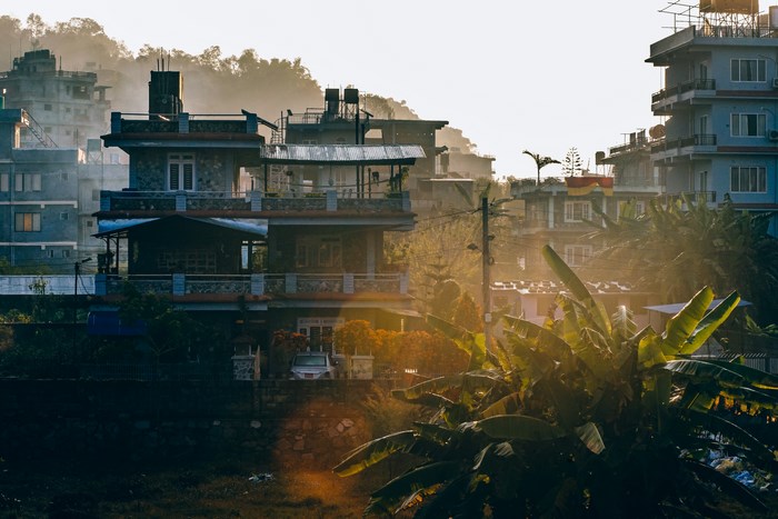 Buildings in a hazy, sunlit urban landscape