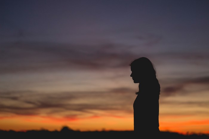 Silhouette of a Black Woman at Sunset