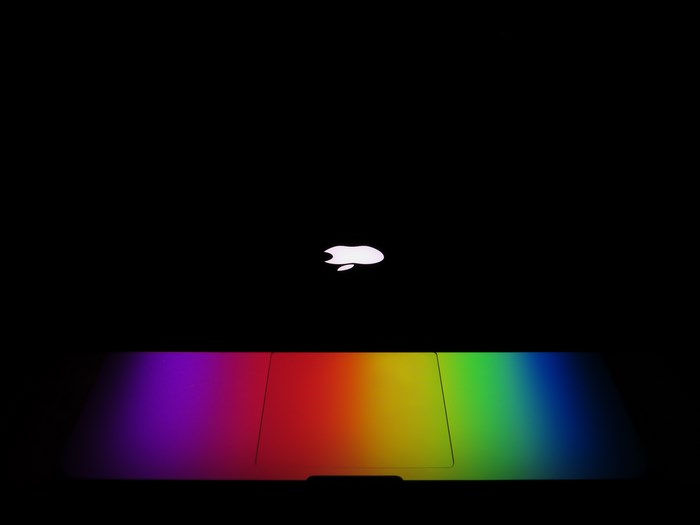 MacBook Trackpad Reflecting Vibrant Rainbow Colors