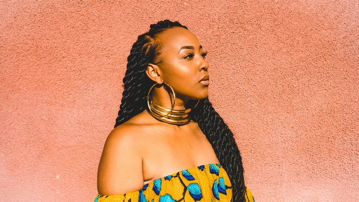 African American woman with braids and gold jewelry