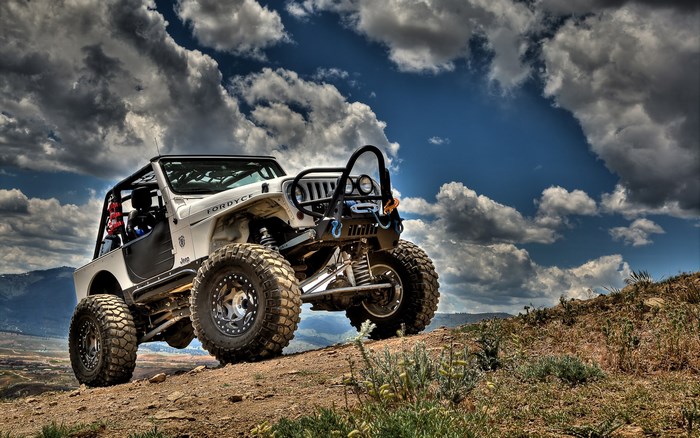 White Jeep off-road vehicle on a hill