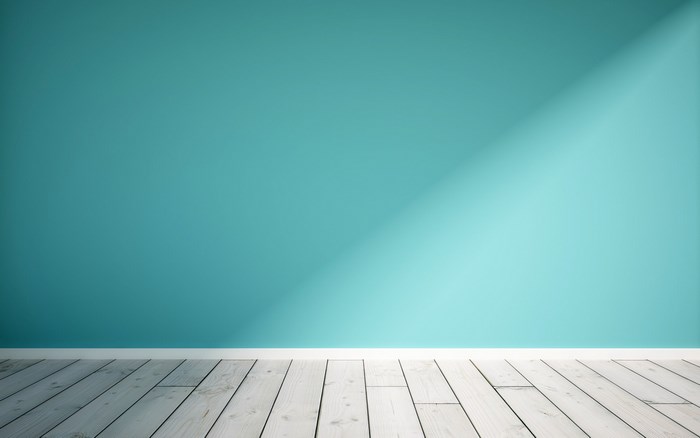 Teal wall and wooden floor with light