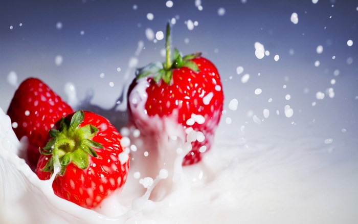 Fresh Strawberries Splashing in Milk