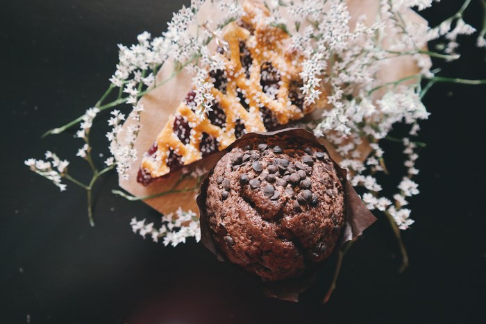 Chocolate muffin and cherry pie slice with white flowers