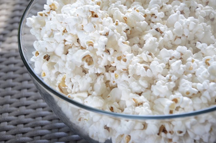 Bowl of popcorn on a woven mat