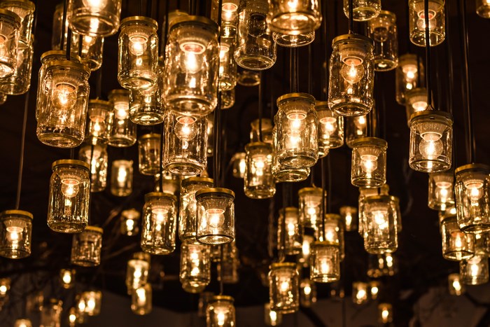 Hanging glass jars with illuminated light bulbs