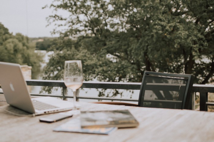 Outdoor Workspace with MacBook Laptop and Wine Glass