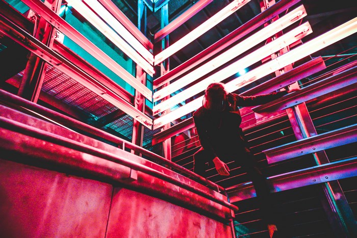 Person in a dark room with neon lights