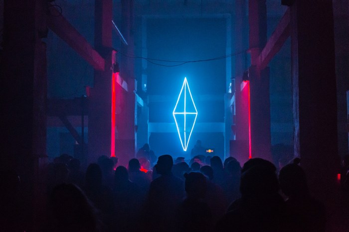 Neon diamond sign at a Moscow rave party
