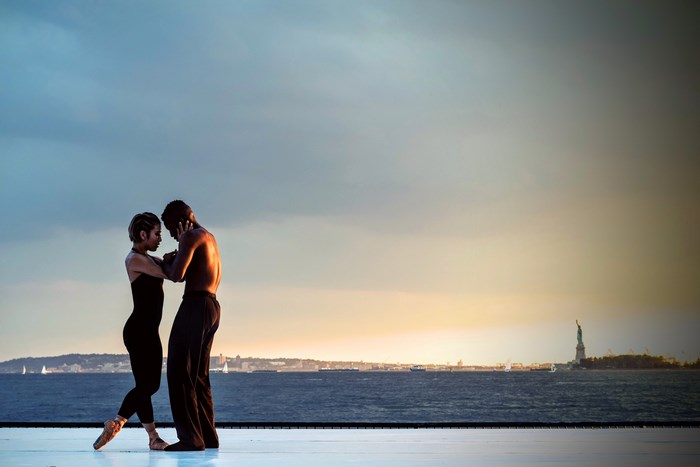 Ballet dancers perform near the Statue of Liberty