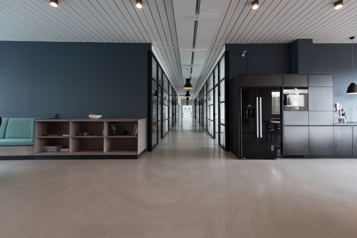 Modern office interior with hallway, kitchen, and lounge area