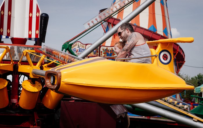 Father and son on a carnival ride