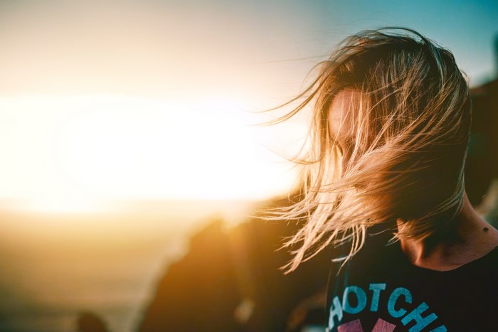 Woman with blonde hair at sunset