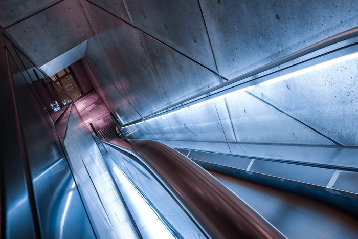 Futuristic escalator with concrete and metal architecture