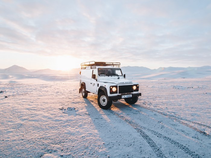 White Land Rover Defender in a Snowy Landscape