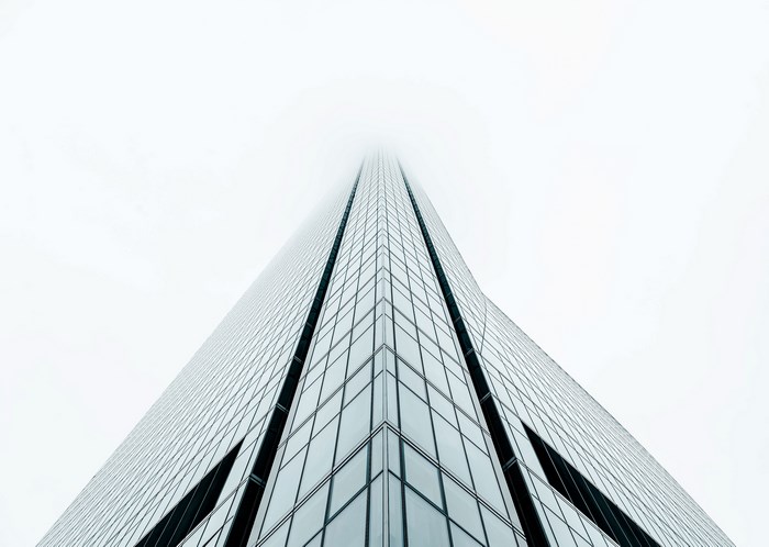 Minimalist skyscraper disappearing into fog